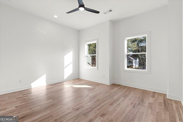 unfurnished room with ceiling fan and light wood-type flooring