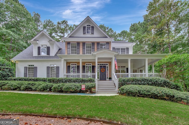 view of front of home featuring covered porch and a front yard