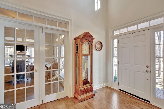 foyer entrance with hardwood / wood-style flooring and french doors