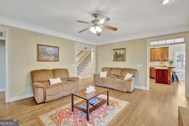 living room with light hardwood / wood-style flooring and ornamental molding