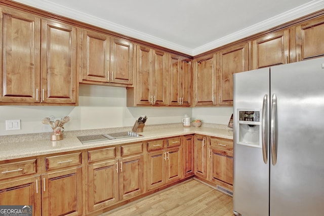 kitchen with light wood-type flooring and stainless steel fridge with ice dispenser