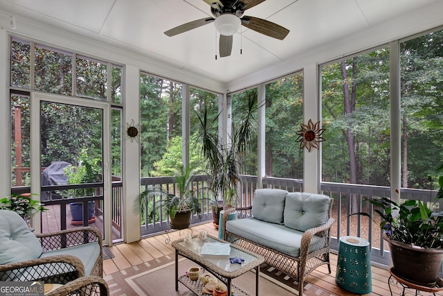 sunroom / solarium featuring ceiling fan