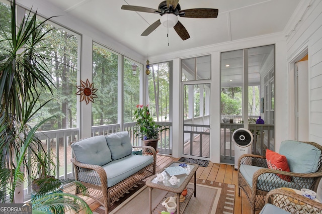 sunroom with a healthy amount of sunlight and ceiling fan