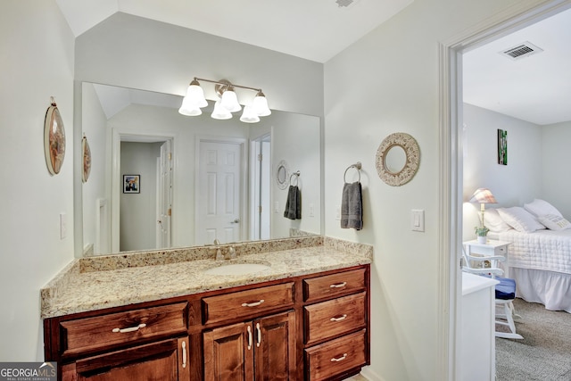 bathroom with vanity and vaulted ceiling