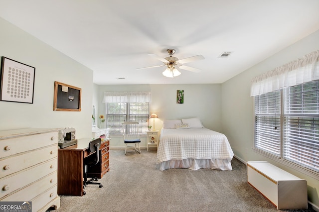 bedroom featuring ceiling fan and light carpet