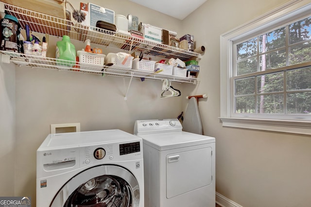 laundry area with washing machine and clothes dryer