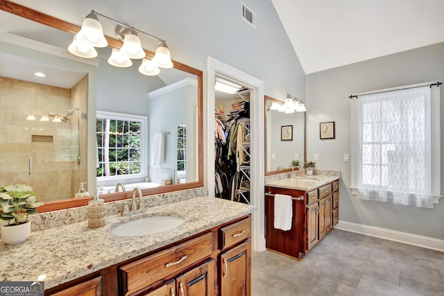 bathroom with walk in shower, tile patterned floors, vanity, and vaulted ceiling