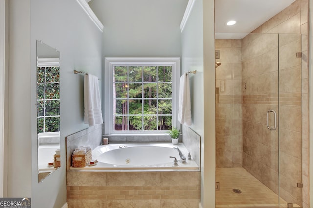 bathroom with ornamental molding and plus walk in shower