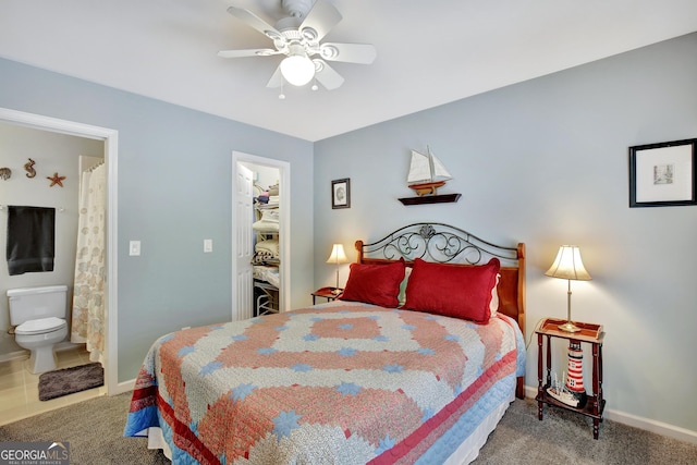 bedroom featuring ceiling fan, connected bathroom, carpet, and a spacious closet