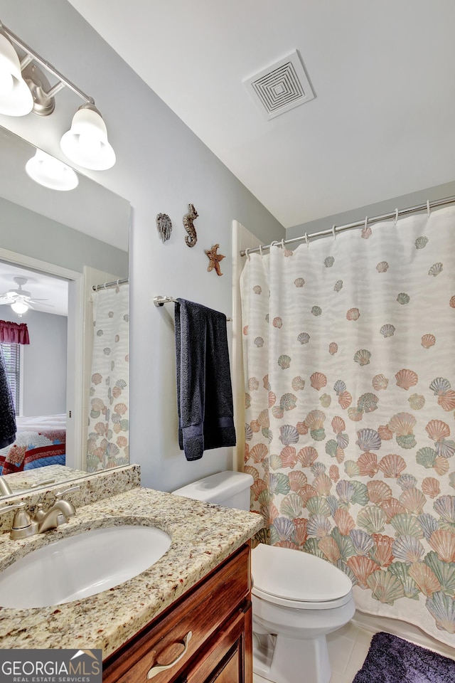 bathroom with vanity, tile patterned floors, ceiling fan, and toilet