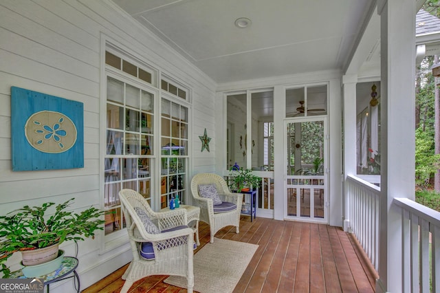 sunroom with ceiling fan and plenty of natural light