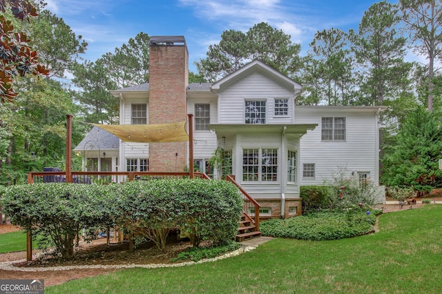 back of house featuring a yard and a deck