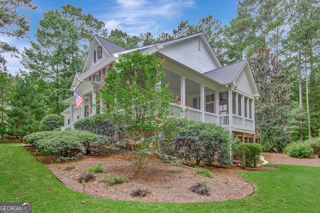 view of home's exterior with a yard and a sunroom