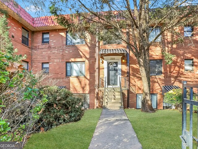 320 3rd St NE Unit 1, Atlanta, GA 30308 - view of front facade featuring brick siding, a front lawn, and a tiled roof