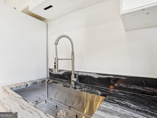 320 3rd St NE Unit 1, Atlanta, GA 30308 - details featuring stone counters, white cabinets, and a sink