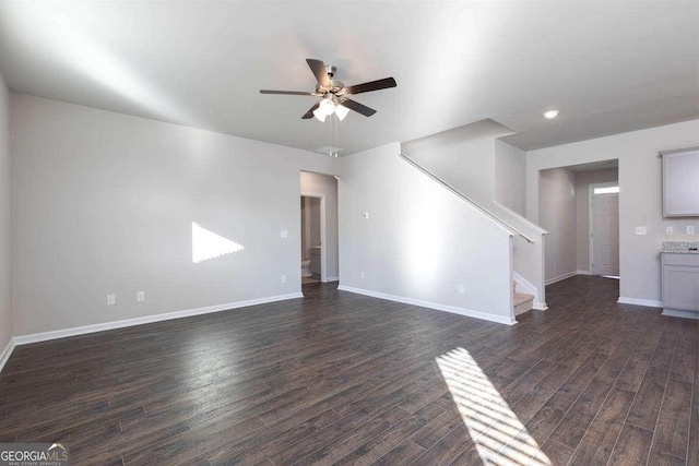 unfurnished living room with ceiling fan and dark wood-type flooring