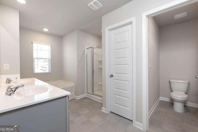 bathroom with vanity, an enclosed shower, and toilet