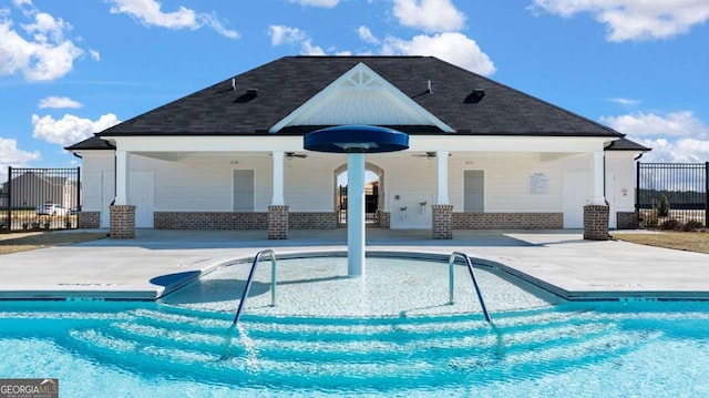 view of swimming pool featuring ceiling fan and a patio