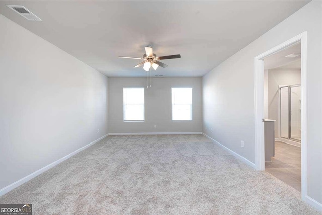 unfurnished room featuring light carpet and ceiling fan