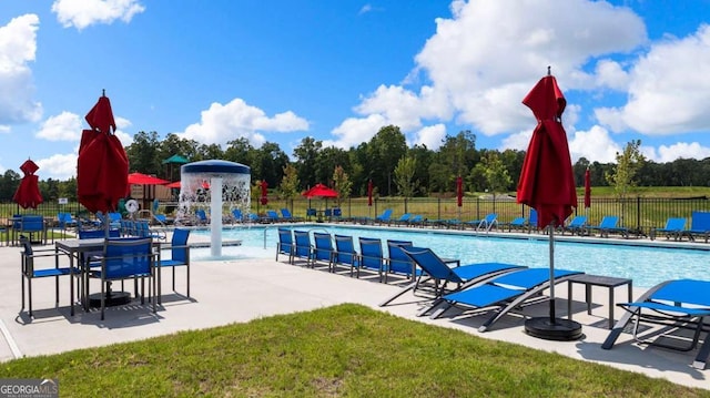 view of pool featuring pool water feature, a yard, and a patio