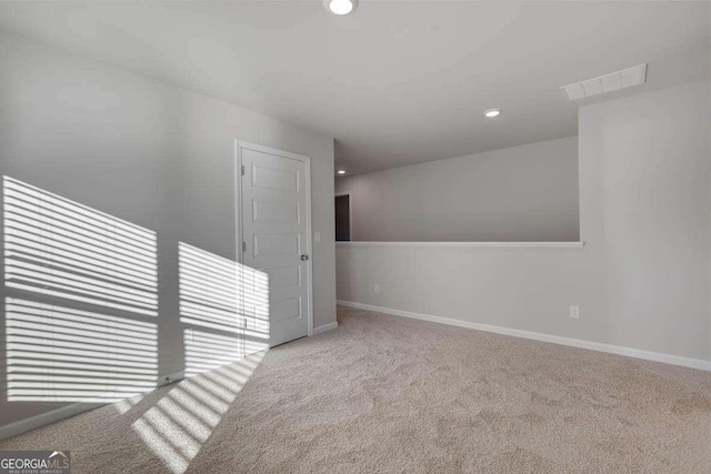 spare room with light colored carpet