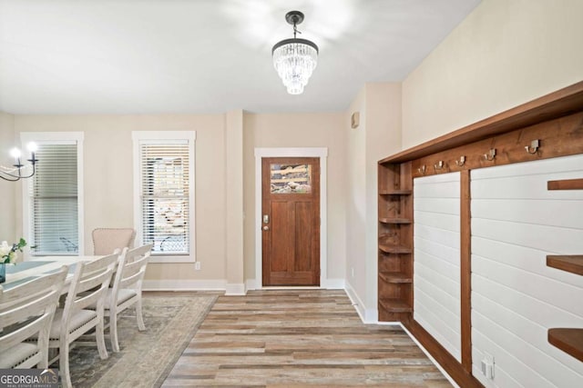 foyer entrance featuring light wood-type flooring and a notable chandelier