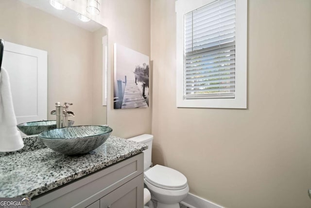 bathroom with toilet and vanity