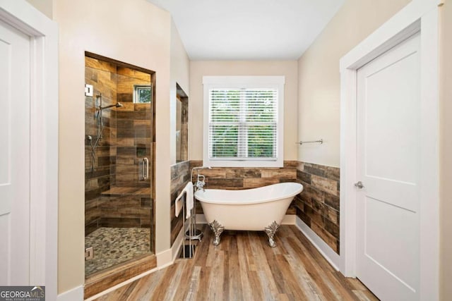 bathroom featuring separate shower and tub, tile walls, and hardwood / wood-style flooring