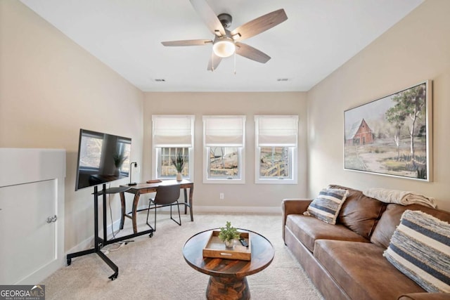 carpeted living room featuring ceiling fan