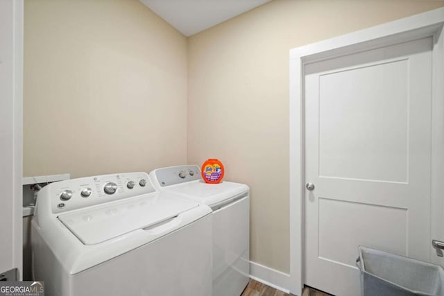 washroom featuring independent washer and dryer and wood-type flooring