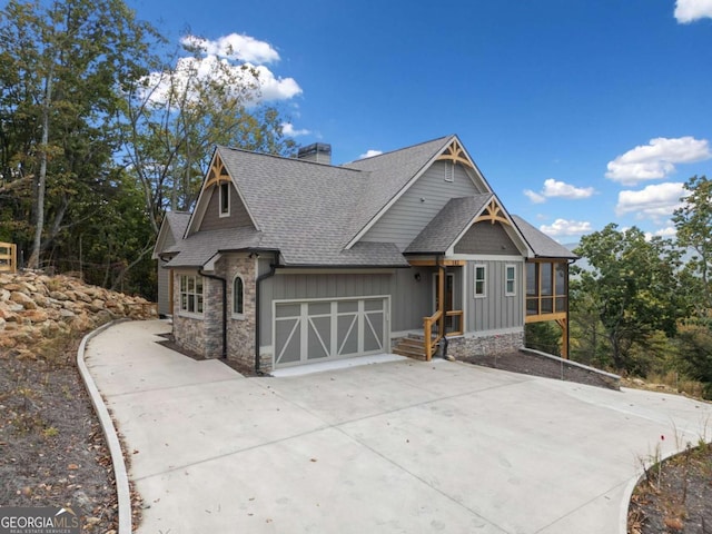 view of front of house with a garage and a sunroom