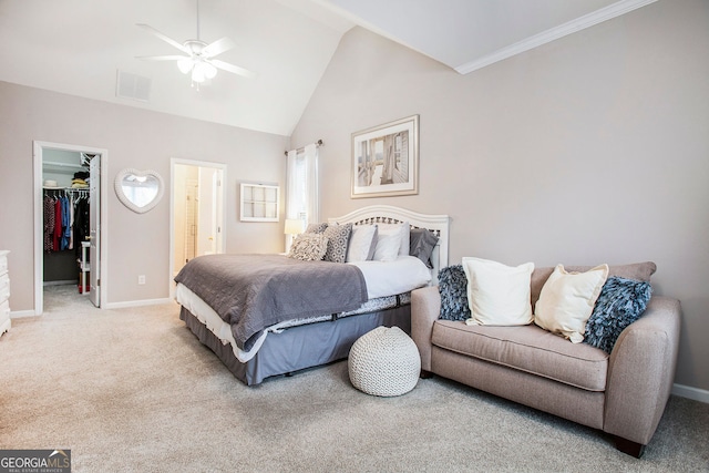 bedroom featuring a spacious closet, ceiling fan, ensuite bathroom, light carpet, and a closet