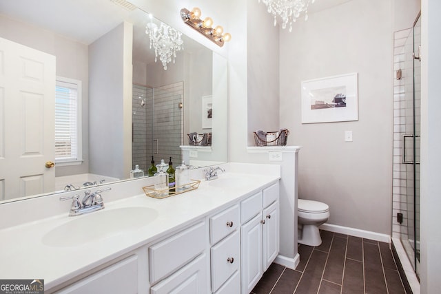 bathroom with a shower with shower door and a chandelier