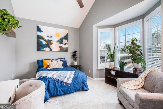 bedroom with ceiling fan, light colored carpet, and lofted ceiling