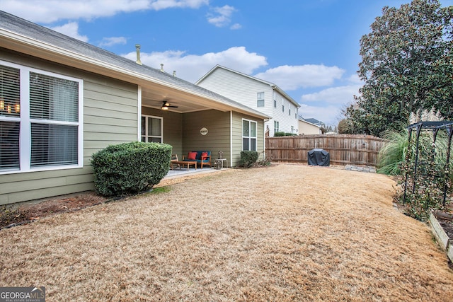 view of yard with ceiling fan and a patio