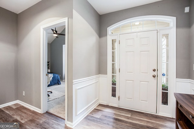 entryway with ceiling fan and wood-type flooring