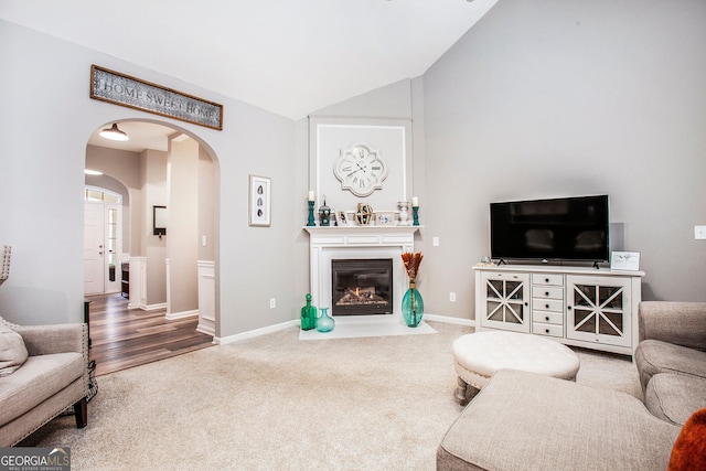 living room featuring carpet and lofted ceiling