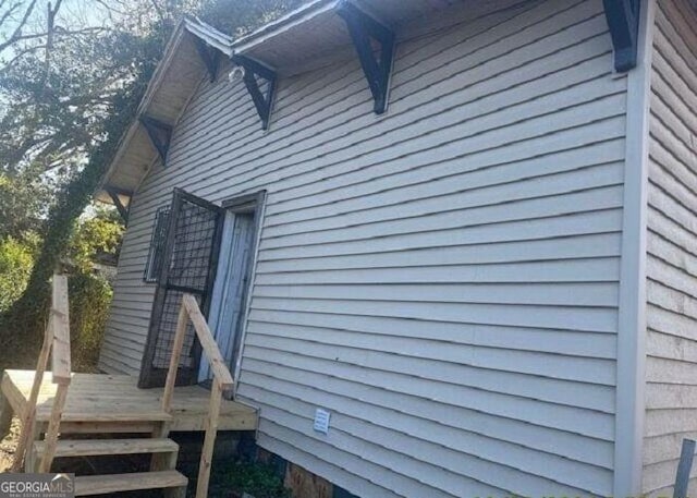 view of side of property featuring a wooden deck