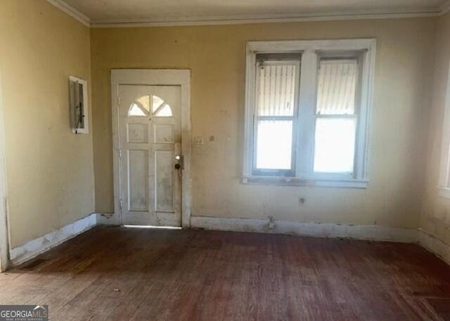 entrance foyer featuring dark hardwood / wood-style flooring and crown molding