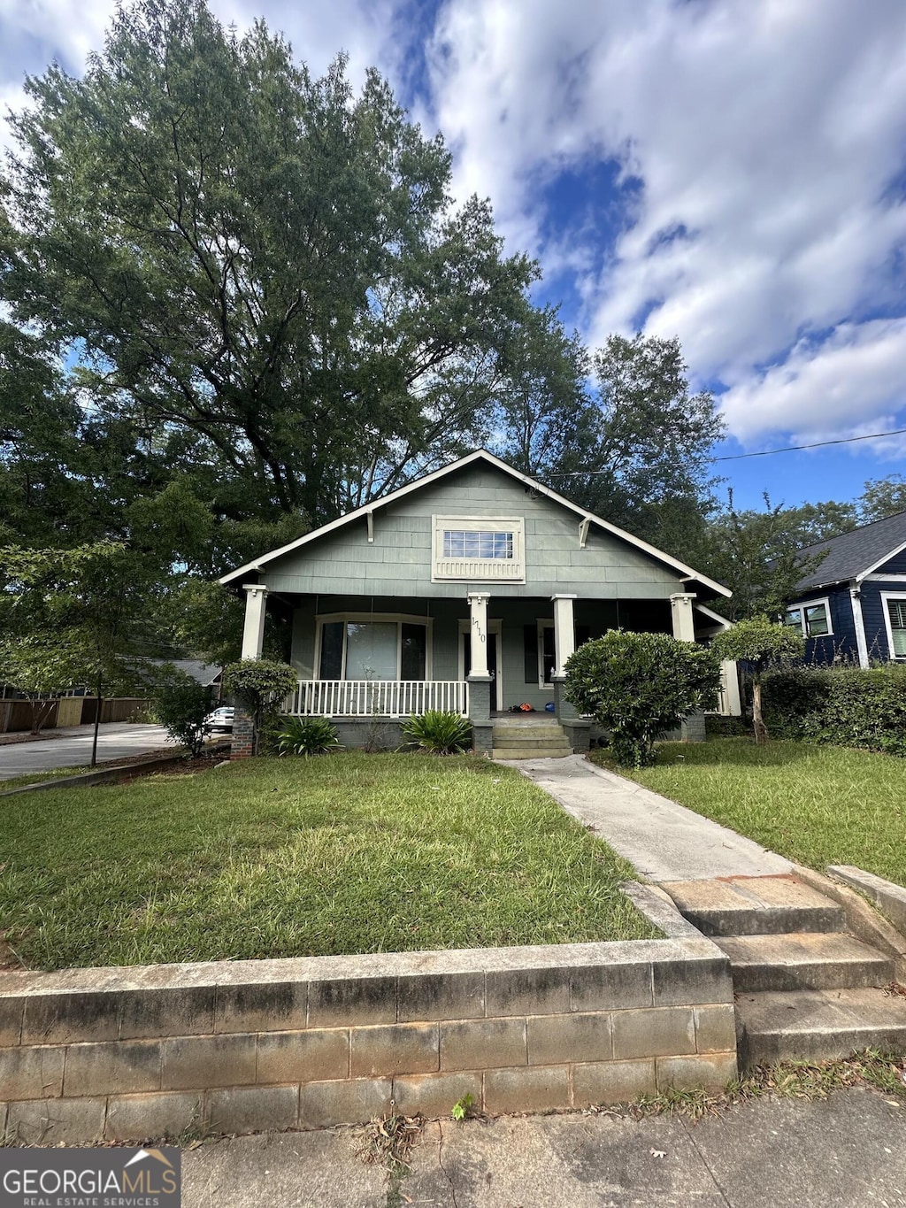 bungalow-style home with a front lawn