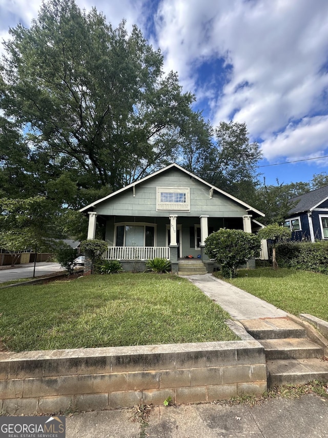 bungalow-style home with a front lawn