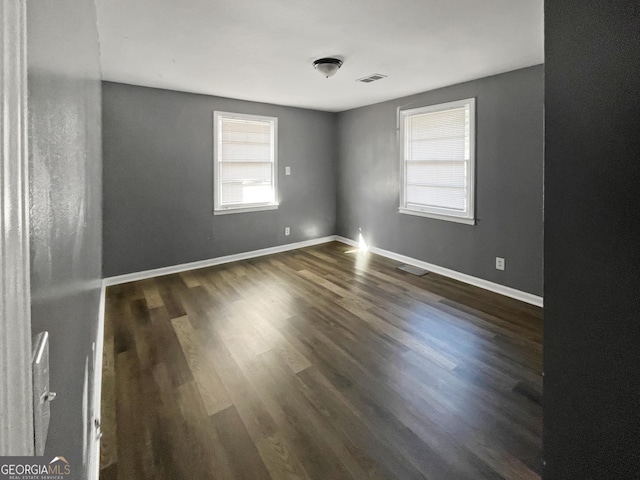 empty room with dark wood-type flooring