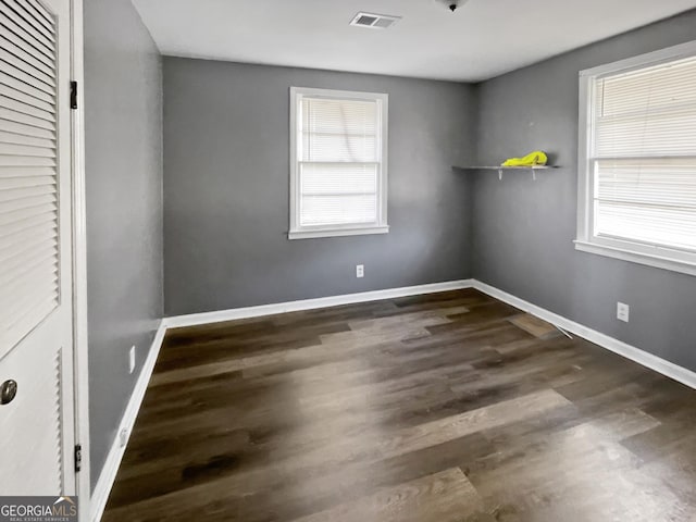 unfurnished bedroom with dark hardwood / wood-style flooring