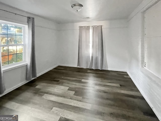 empty room featuring dark hardwood / wood-style flooring