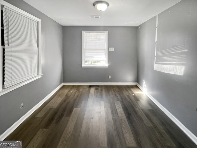 spare room with dark hardwood / wood-style flooring