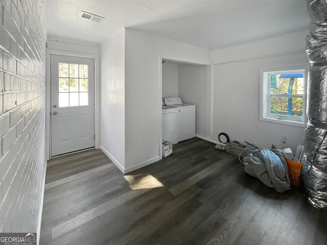 laundry area with dark hardwood / wood-style flooring and washing machine and clothes dryer