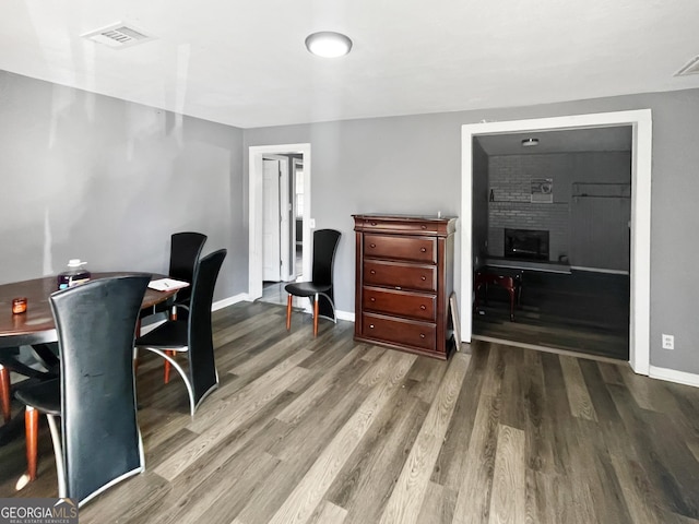 office area featuring hardwood / wood-style flooring and a brick fireplace