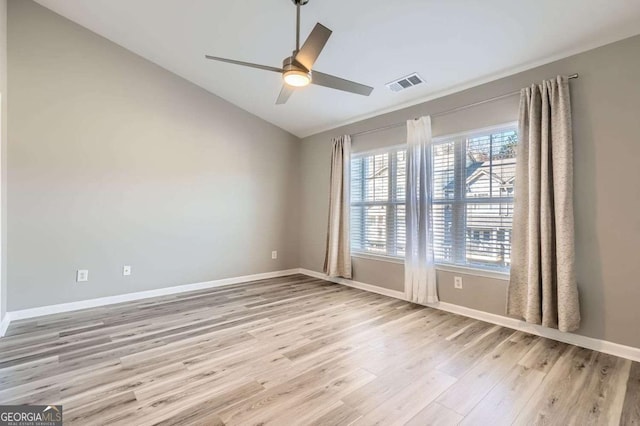 unfurnished room with ceiling fan, light hardwood / wood-style floors, and vaulted ceiling