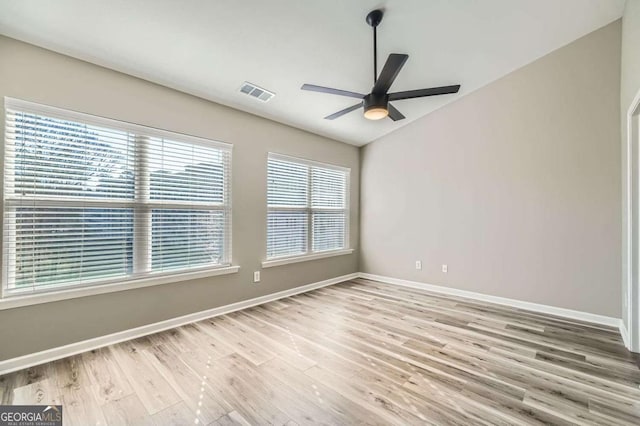 empty room with ceiling fan and hardwood / wood-style flooring