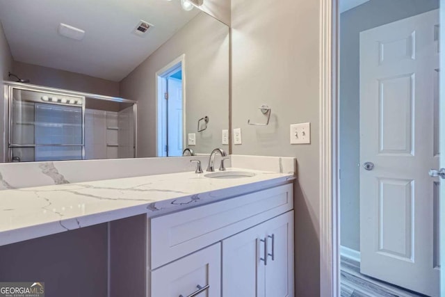 bathroom with vanity and hardwood / wood-style flooring